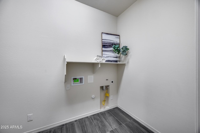 clothes washing area with washer hookup, hookup for a gas dryer, baseboards, hookup for an electric dryer, and laundry area