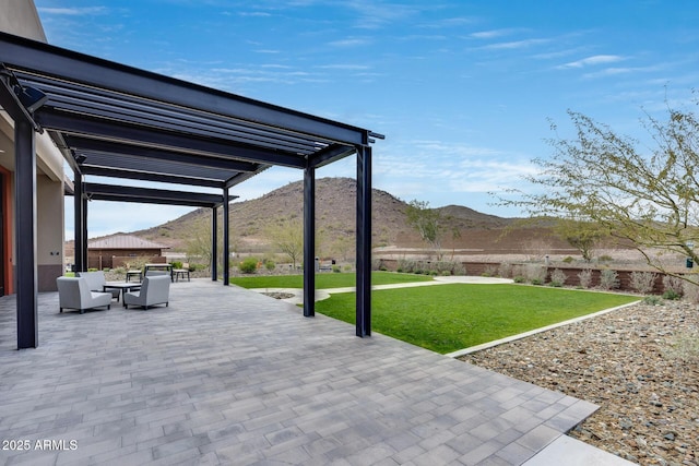 view of patio / terrace featuring a mountain view, an outdoor hangout area, and a pergola