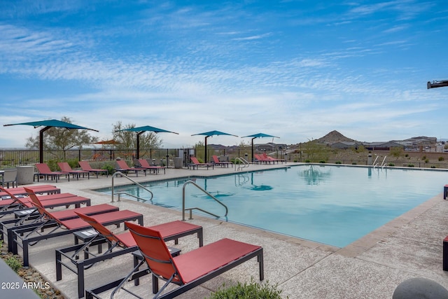 community pool featuring a patio and fence