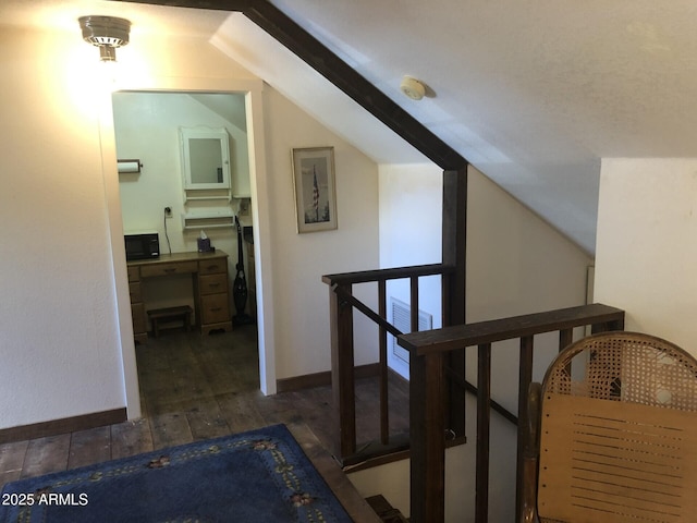 corridor featuring dark hardwood / wood-style floors and lofted ceiling