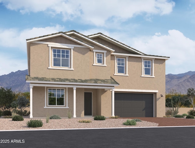 view of front of property featuring a garage and a mountain view