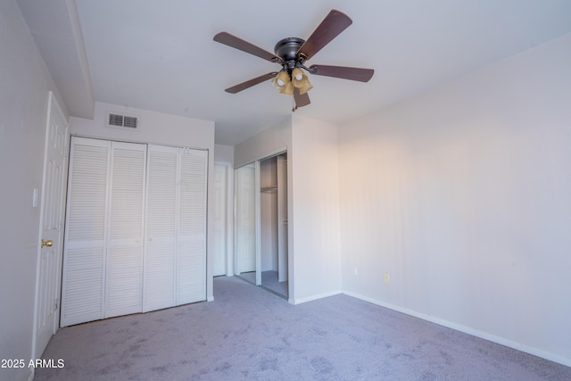 unfurnished bedroom featuring ceiling fan and light colored carpet