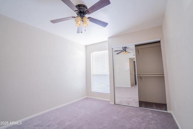 unfurnished bedroom with ceiling fan, a closet, and carpet floors