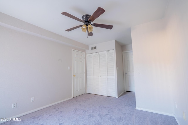 unfurnished bedroom featuring ceiling fan and light carpet