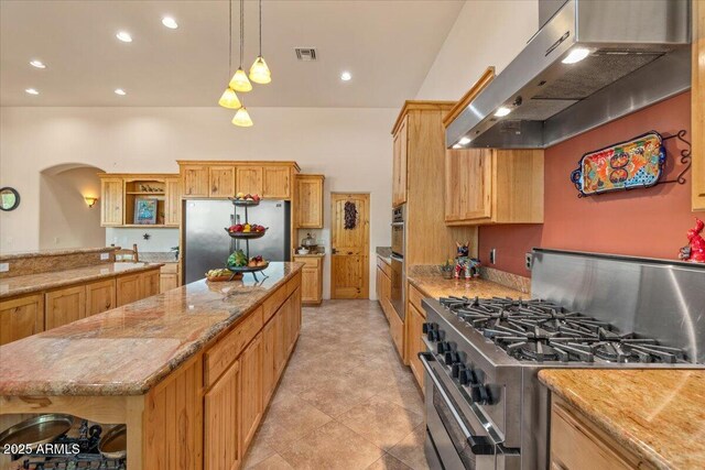 9435 E Hobart Cir, Mesa, AZ 85207 - kitchen with stainless steel appliances, extractor fan, open shelves, a center island, and light stone countertops