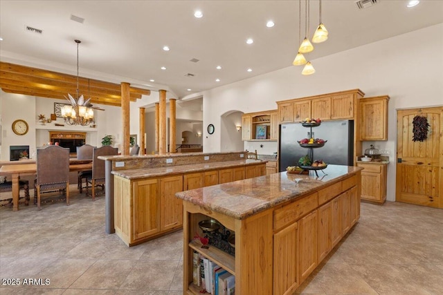 9435 E Hobart Cir, Mesa, AZ 85207 - kitchen with freestanding refrigerator, open shelves, a center island, arched walkways, and recessed lighting