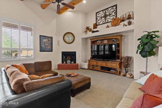 9435 E Hobart Cir, Mesa, AZ 85207 - carpeted living room with a ceiling fan, a towering ceiling, beamed ceiling, and a fireplace