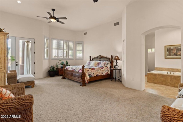 9435 E Hobart Cir, Mesa, AZ 85207 - bedroom with arched walkways, carpet flooring, a ceiling fan, and access to exterior