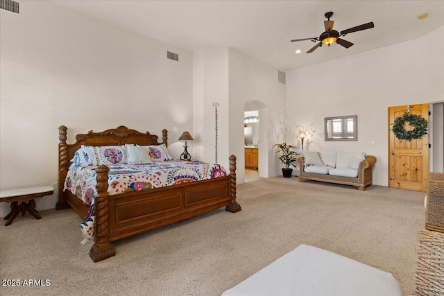 9435 E Hobart Cir, Mesa, AZ 85207 - carpeted bedroom with arched walkways, a towering ceiling, connected bathroom, and a ceiling fan