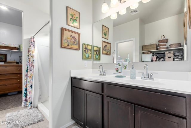 bathroom with a shower with curtain, vanity, and tile patterned flooring