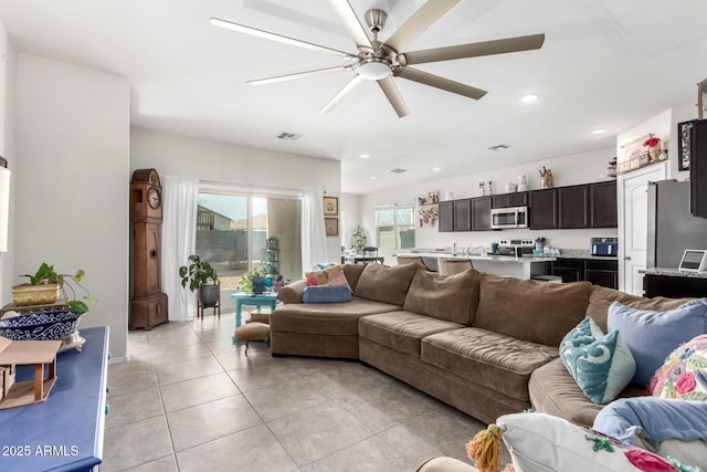 tiled living room featuring ceiling fan