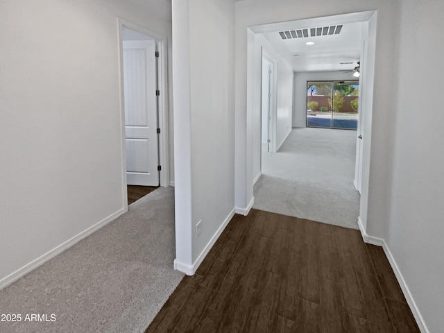 hallway featuring dark carpet