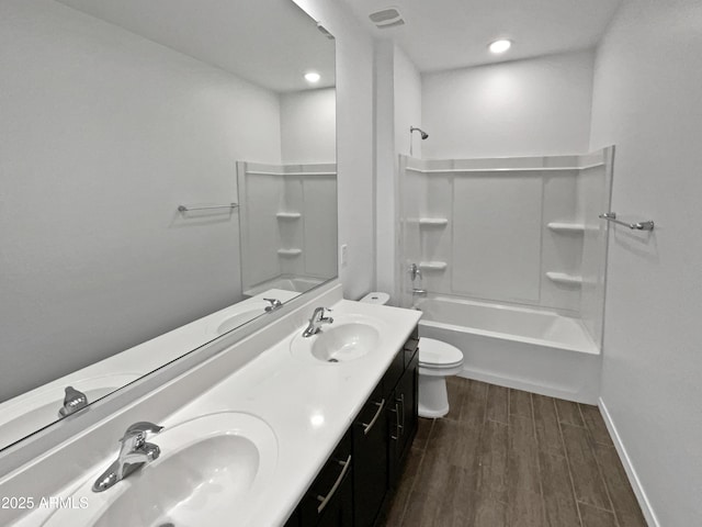 full bathroom with wood-type flooring, toilet, shower / bathing tub combination, and vanity