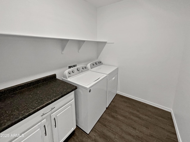 clothes washing area featuring cabinets, washing machine and dryer, and dark wood-type flooring