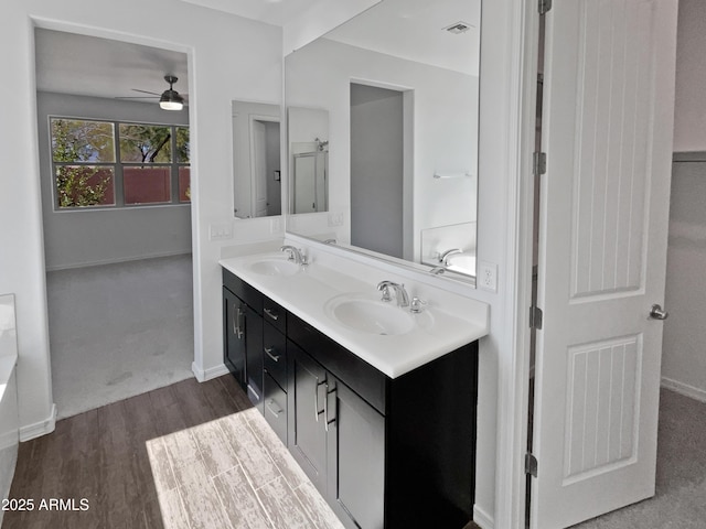 bathroom featuring hardwood / wood-style flooring, vanity, and ceiling fan