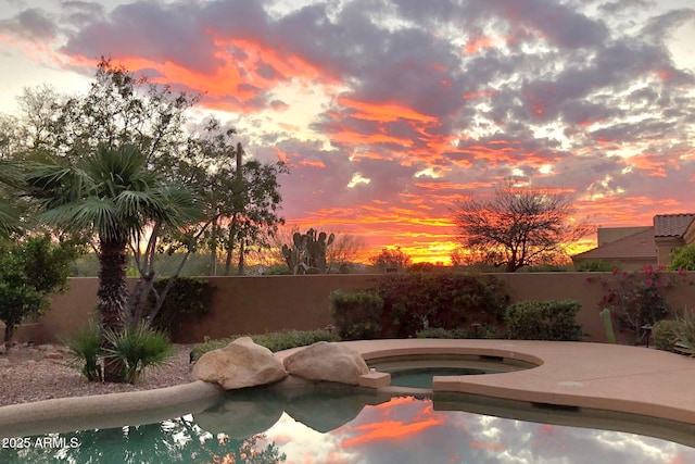 view of pool featuring an in ground hot tub and fence private yard