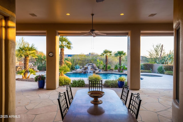 view of patio with a jacuzzi, a ceiling fan, and a fenced in pool