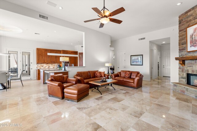 living area featuring visible vents, recessed lighting, a fireplace, and ceiling fan