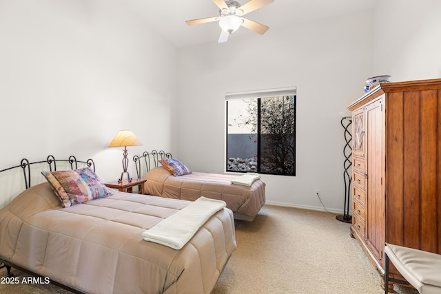 bedroom featuring light carpet, a ceiling fan, and baseboards