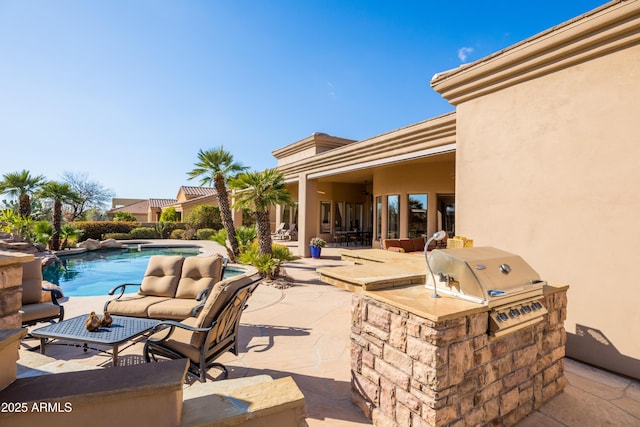 view of patio featuring area for grilling, an outdoor kitchen, and an outdoor pool