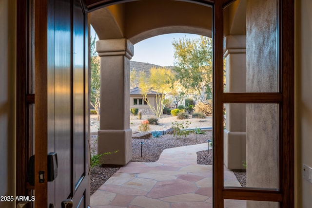 entryway with a mountain view and arched walkways