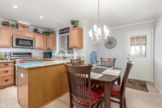 1925 W 12th Ave, Apache Junction, AZ 85120 - kitchen with appliances with stainless steel finishes, a chandelier, crown molding, light stone countertops, and a peninsula