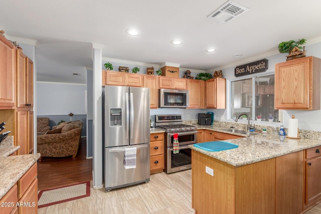 1925 W 12th Ave, Apache Junction, AZ 85120 - kitchen featuring appliances with stainless steel finishes, ornamental molding, a peninsula, light stone counters, and recessed lighting