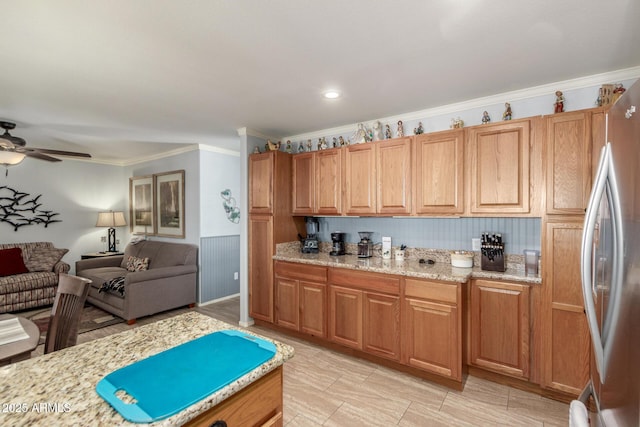 1925 W 12th Ave, Apache Junction, AZ 85120 - kitchen featuring freestanding refrigerator, open floor plan, a ceiling fan, crown molding, and light stone countertops