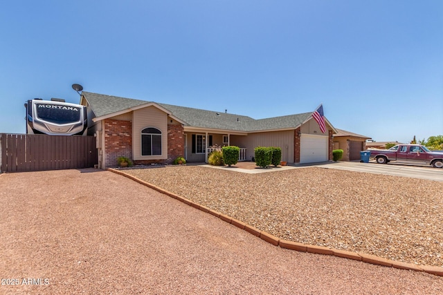 1925 W 12th Ave, Apache Junction, AZ 85120 - ranch-style house with concrete driveway, an attached garage, brick siding, a shingled roof, and a gate