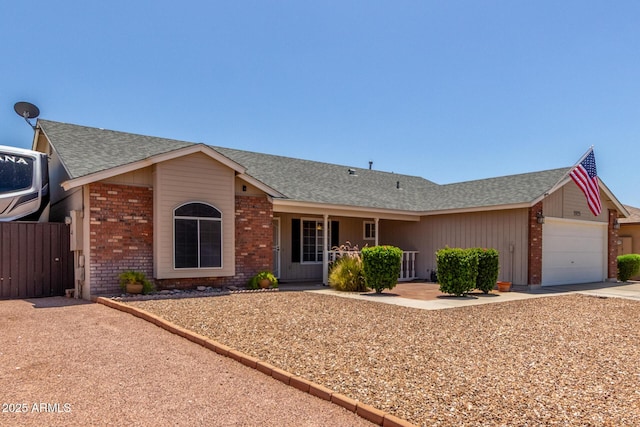 1925 W 12th Ave, Apache Junction, AZ 85120 - ranch-style house featuring brick siding, an attached garage, roof with shingles, driveway, and a porch
