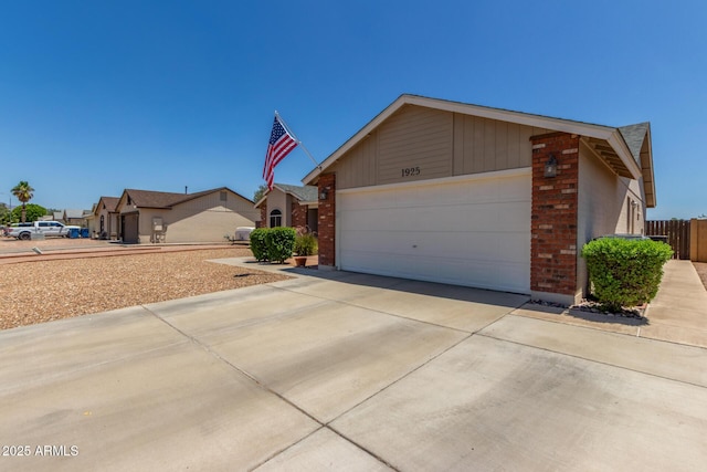 1925 W 12th Ave, Apache Junction, AZ 85120 - view of front of home featuring an attached garage, concrete driveway, and brick siding