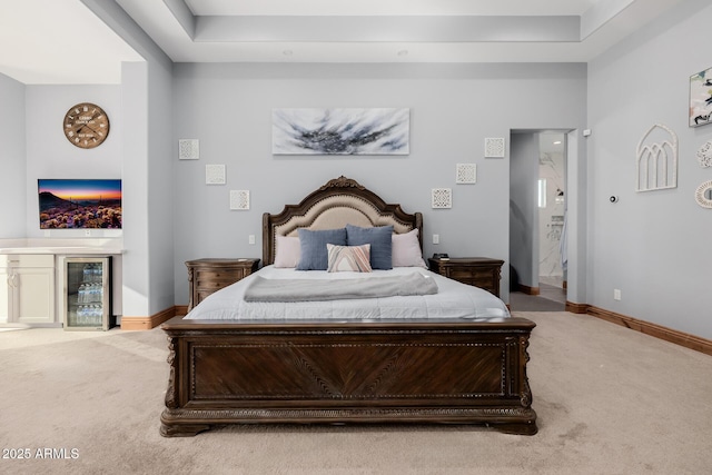 bedroom with baseboards, carpet floors, bar, and beverage cooler