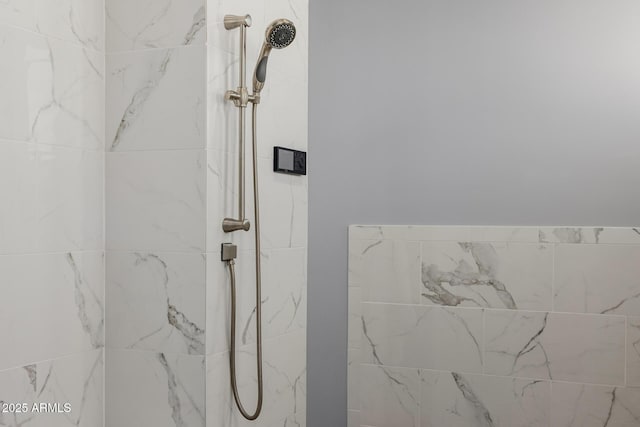 bathroom featuring a marble finish shower