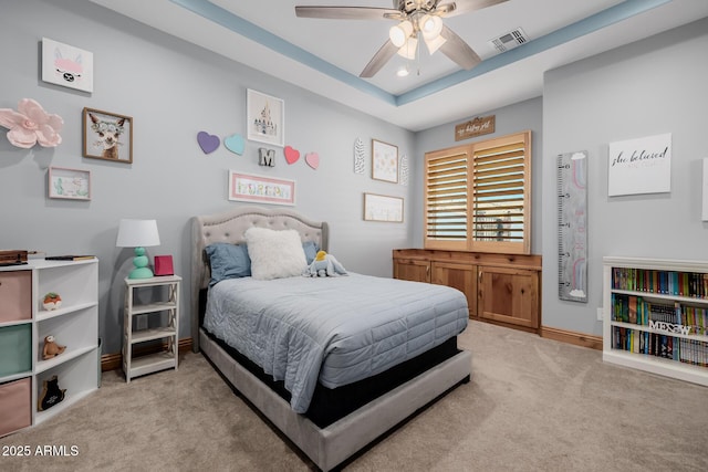 bedroom featuring visible vents, a ceiling fan, baseboards, carpet flooring, and a raised ceiling