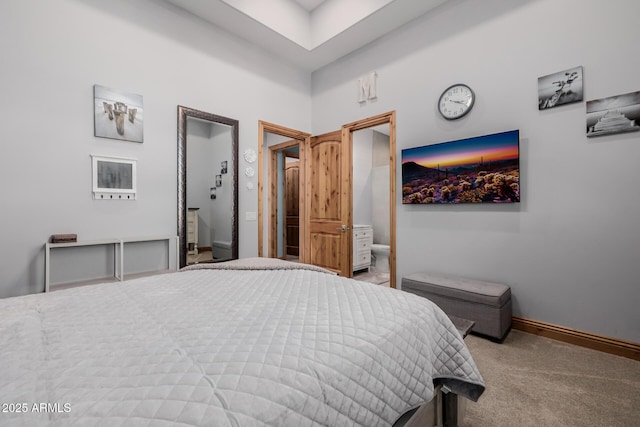 bedroom featuring connected bathroom, baseboards, and carpet floors