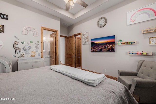 bedroom with baseboards and ensuite bathroom