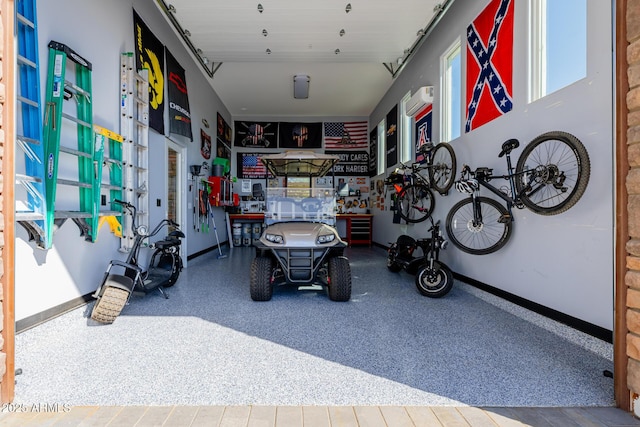 garage with baseboards and a wall mounted air conditioner