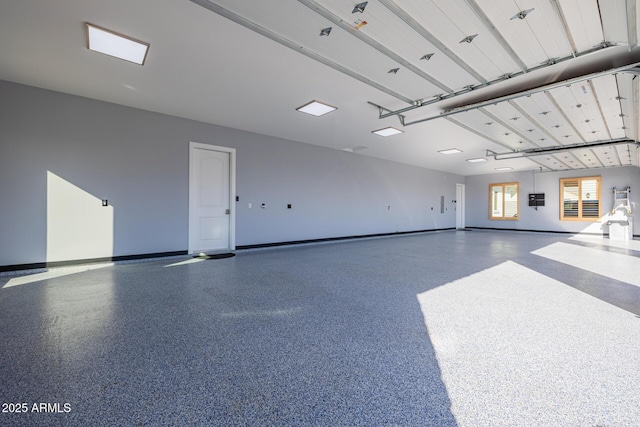 garage featuring electric panel and baseboards