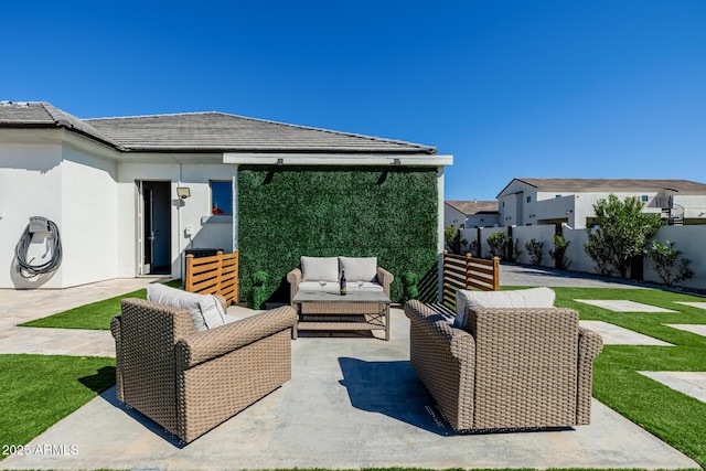 view of patio featuring outdoor lounge area and fence