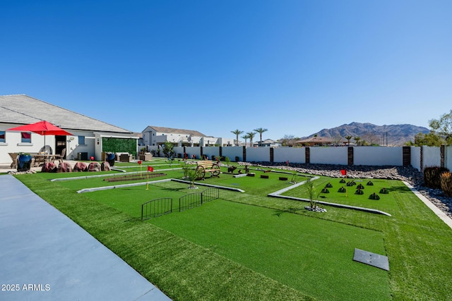 view of home's community with a mountain view and fence