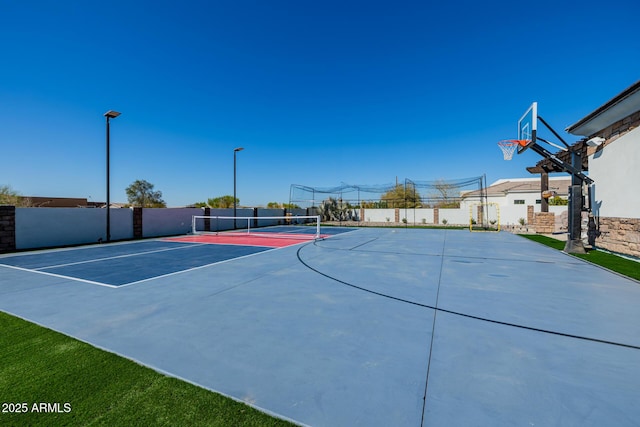 view of sport court featuring community basketball court, a tennis court, and fence