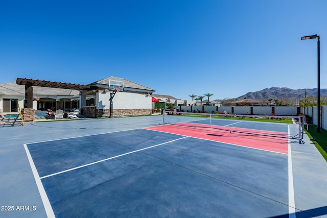 view of basketball court with a tennis court, fence, community basketball court, and a pergola