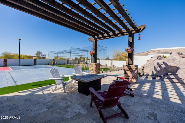 view of patio with a fire pit, a pergola, and fence