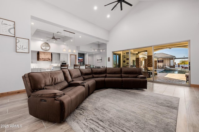 living room with recessed lighting, light wood-style flooring, high vaulted ceiling, and ceiling fan