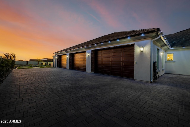 garage featuring decorative driveway