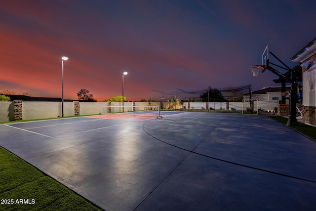 view of basketball court with community basketball court and fence