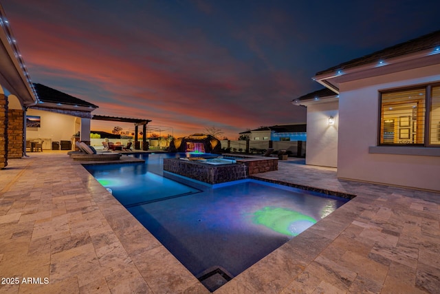 view of swimming pool with fence, a pool with connected hot tub, and a patio area