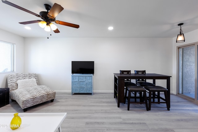 dining space featuring light hardwood / wood-style floors and ceiling fan