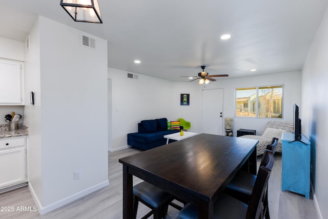 dining space with ceiling fan and light hardwood / wood-style floors