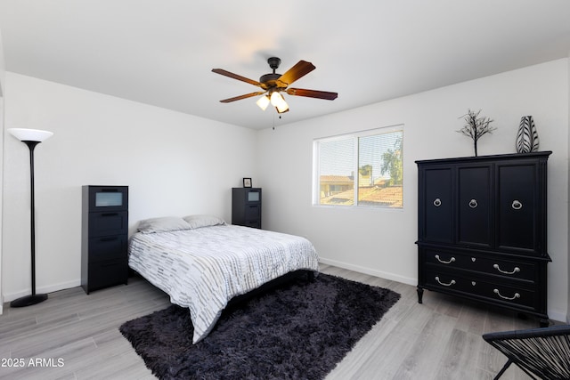 bedroom with light wood-type flooring and ceiling fan